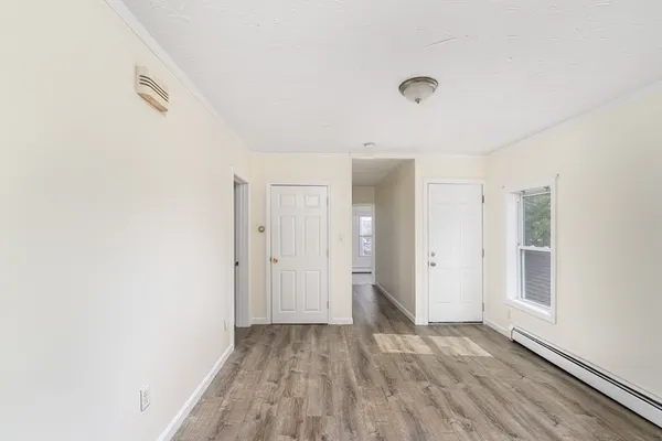 a view of a livingroom with wooden floor and a window