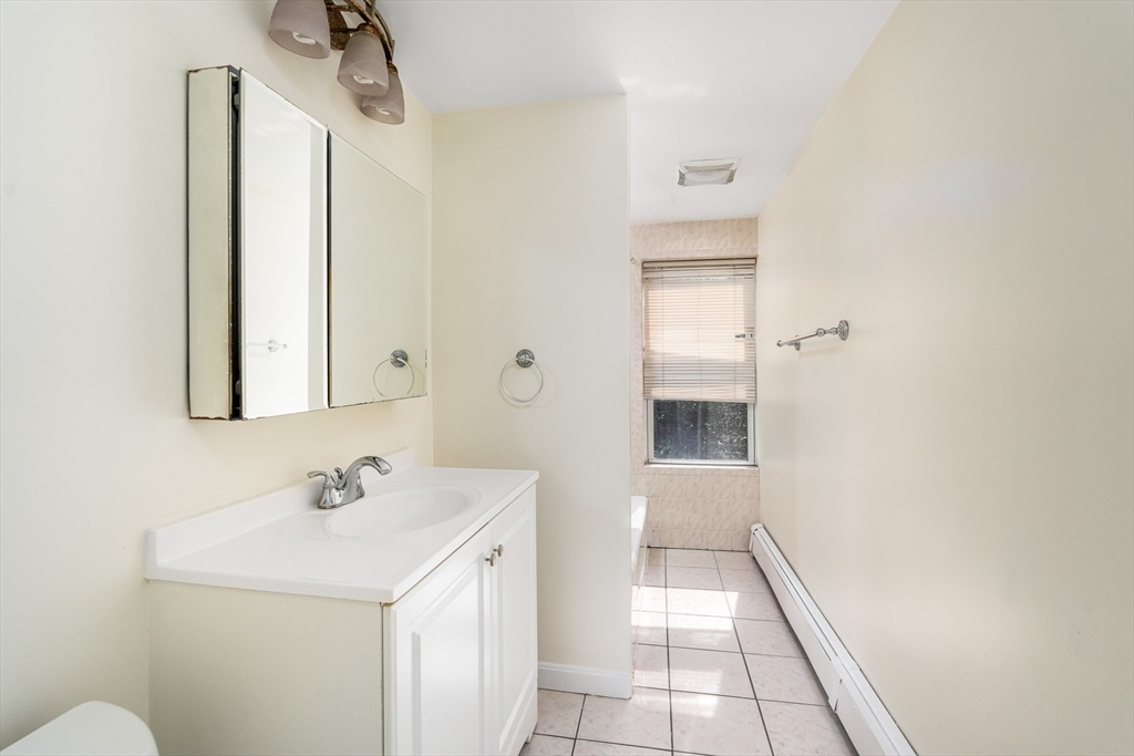 111 Washington Street, Unit 2 Somerville, MA 02145 - Photo 9 of 14 a bathroom with a sink a toilet and shower