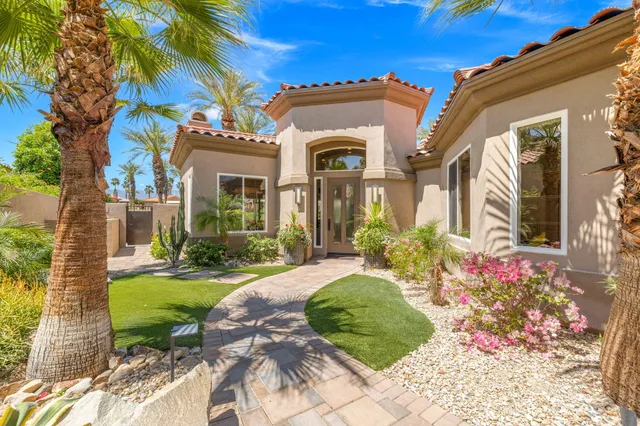 a hallway with painting on the wall and a window