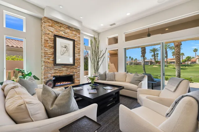 a living room with furniture and large windows