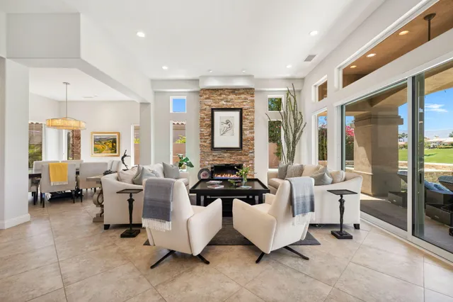 a living room with furniture and large windows