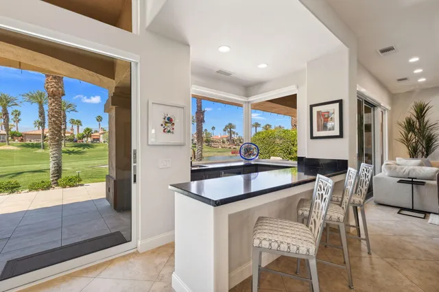 a view of a two chairs in the balcony