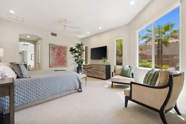 a bedroom with a bed and glass couch