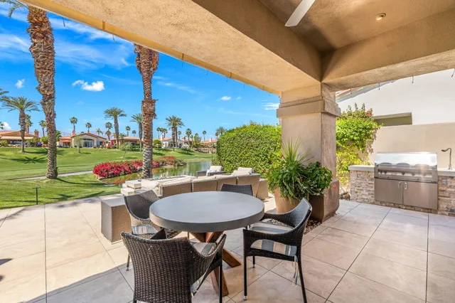 a backyard of a house with table and chairs