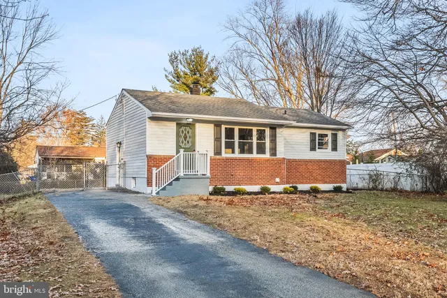 a view of a house with a yard in the background