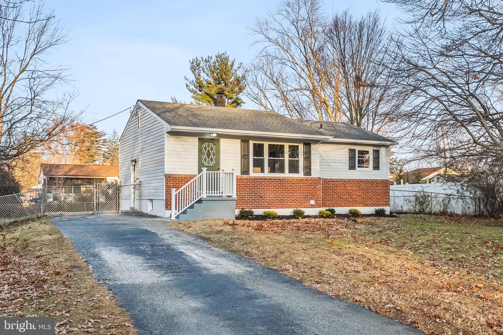 a view of a house with a yard in the background