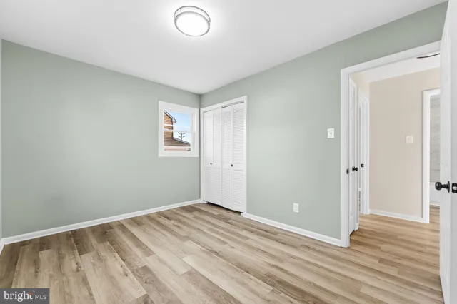 a view of room with wooden floor and window