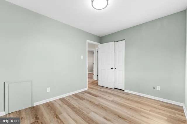 a view of a room with wooden floor and white walls