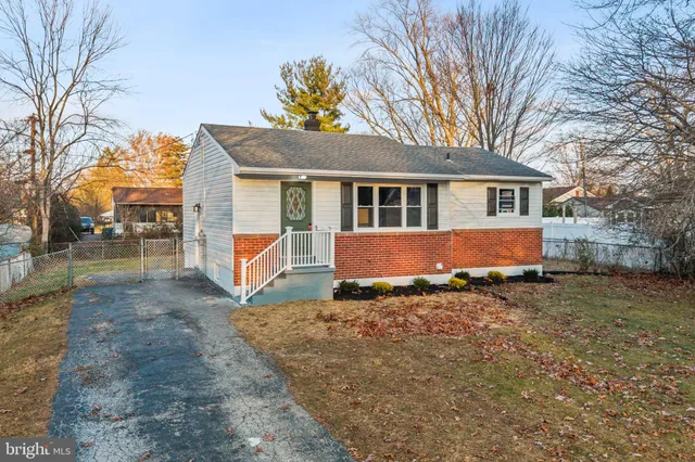 a front view of a house with a yard covered in snow