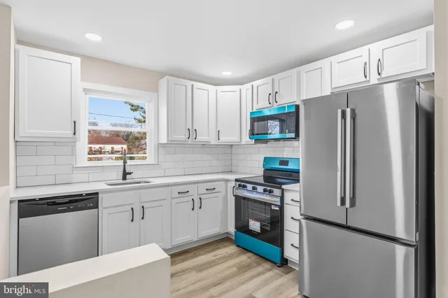a kitchen with stainless steel appliances a refrigerator stove and sink