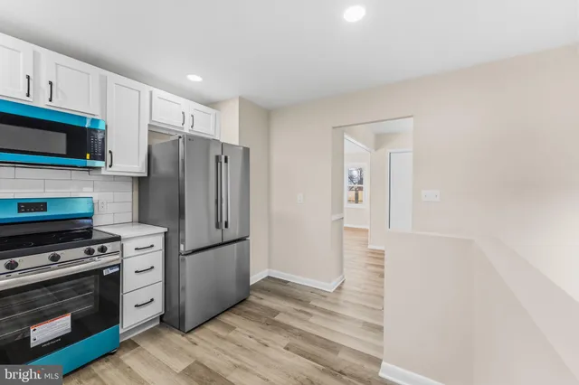 a kitchen with stainless steel appliances a refrigerator stove and microwave