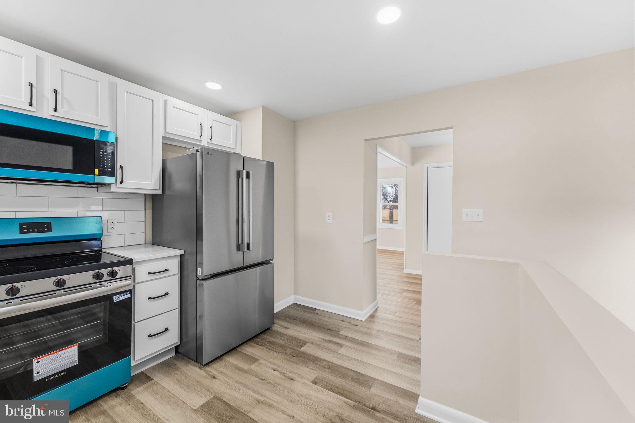 819 Old Harmony Road Newark, DE 19711 - Photo 8 of 39 a kitchen with stainless steel appliances a refrigerator stove and microwave