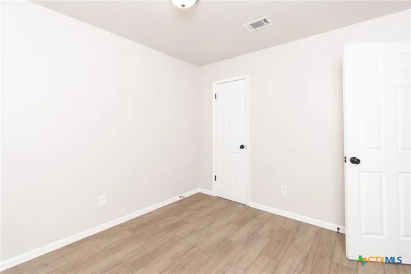 a view of a room with wooden floor