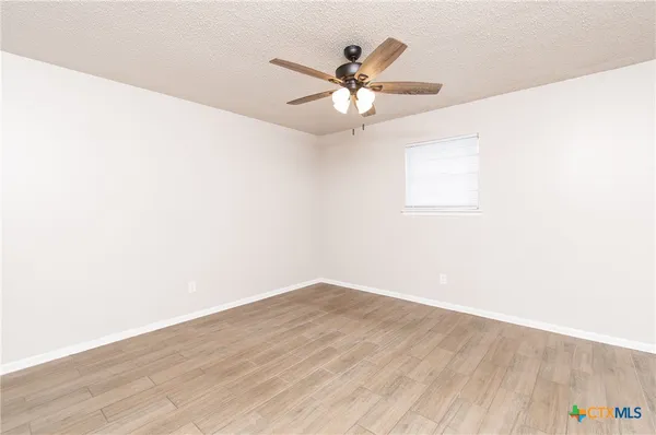 a view of a big room with wooden floor and closet