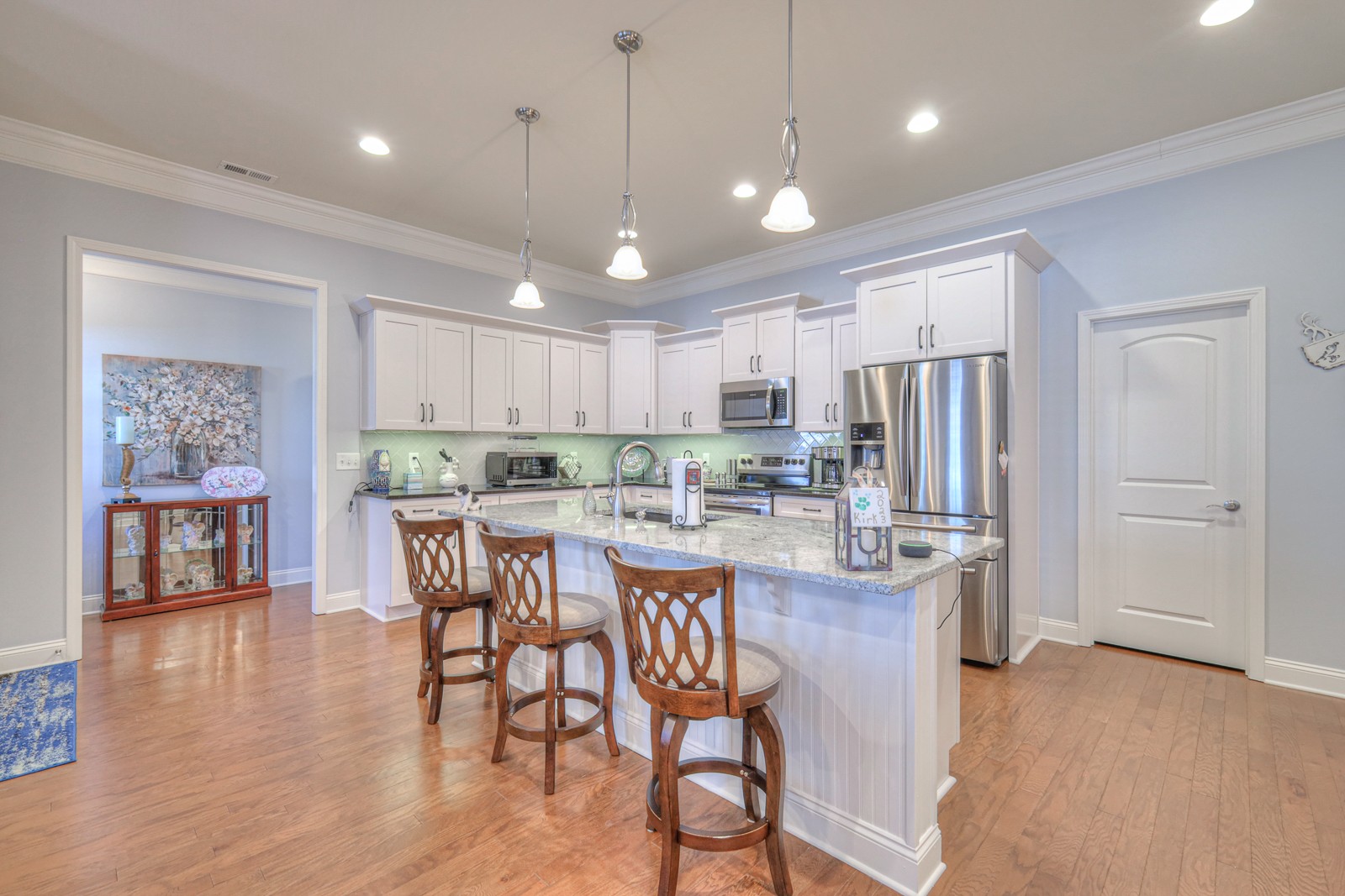 2252 Stonecenter Lane Murfreesboro, TN 37128 - Photo 12 of 36 a kitchen with stainless steel appliances a dining table chairs refrigerator and microwave