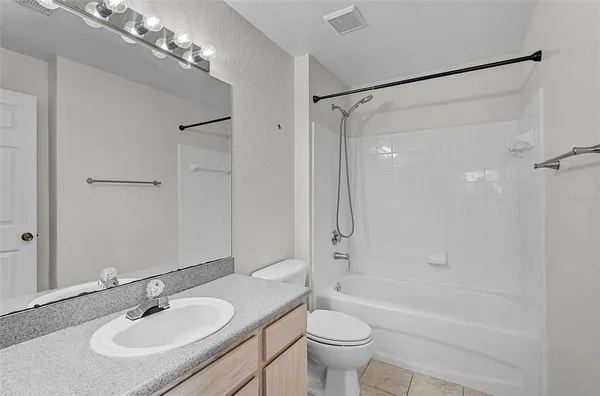 a bathroom with a sink toilet a mirror and shower