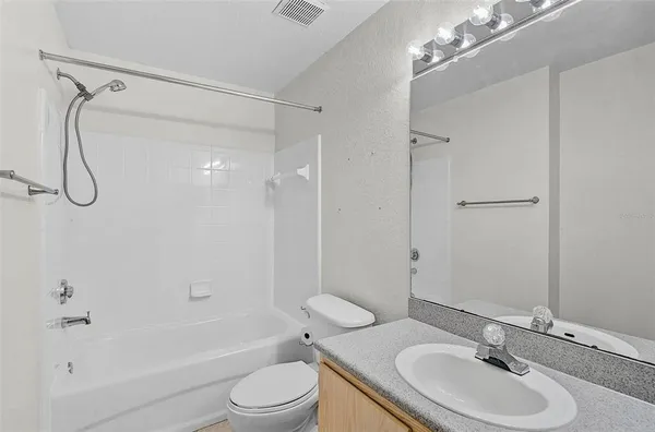 a bathroom with a sink a toilet and a shower