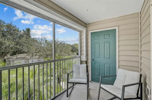a view of a chair and table in the balcony