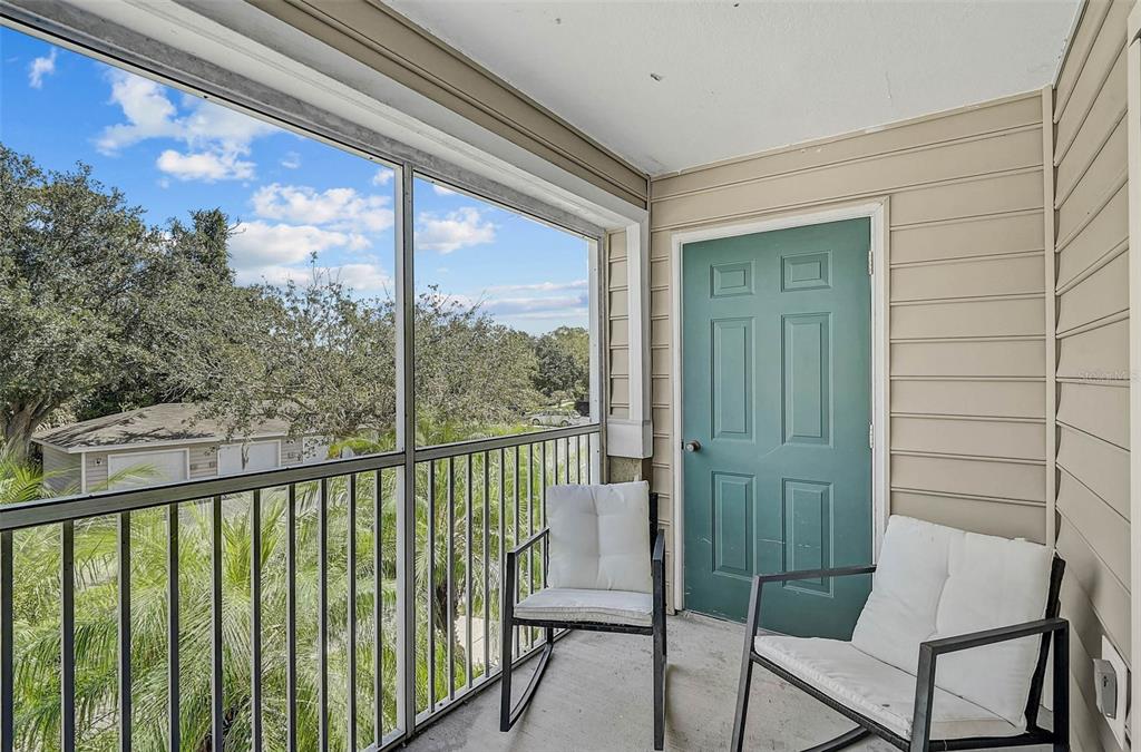 8827 Manor Loop, Unit 204 Lakewood Ranch, FL 34202 - Photo 2 of 31 a view of a chair and table in the balcony