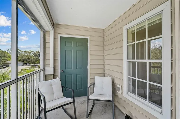 a view of chair in the balcony with wooden floor and fence