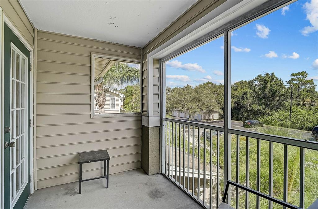 8827 Manor Loop, Unit 204 Lakewood Ranch, FL 34202 - Photo 22 of 31 a view of a porch with a bench
