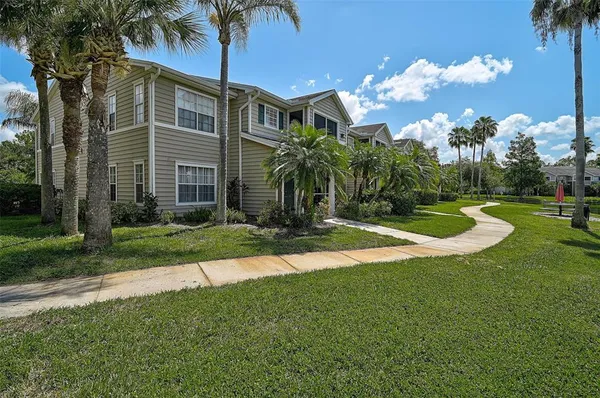 a front view of a house with yard and green space