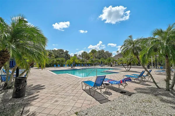 a view of swimming pool with a table and chairs