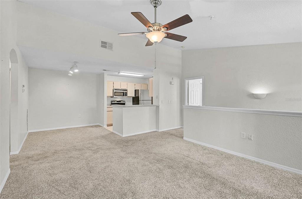 8827 Manor Loop, Unit 204 Lakewood Ranch, FL 34202 - Photo 7 of 31 a view of a kitchen with a sink and a refrigerator