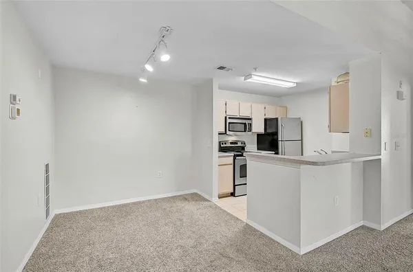 a view of kitchen with refrigerator sink and microwave