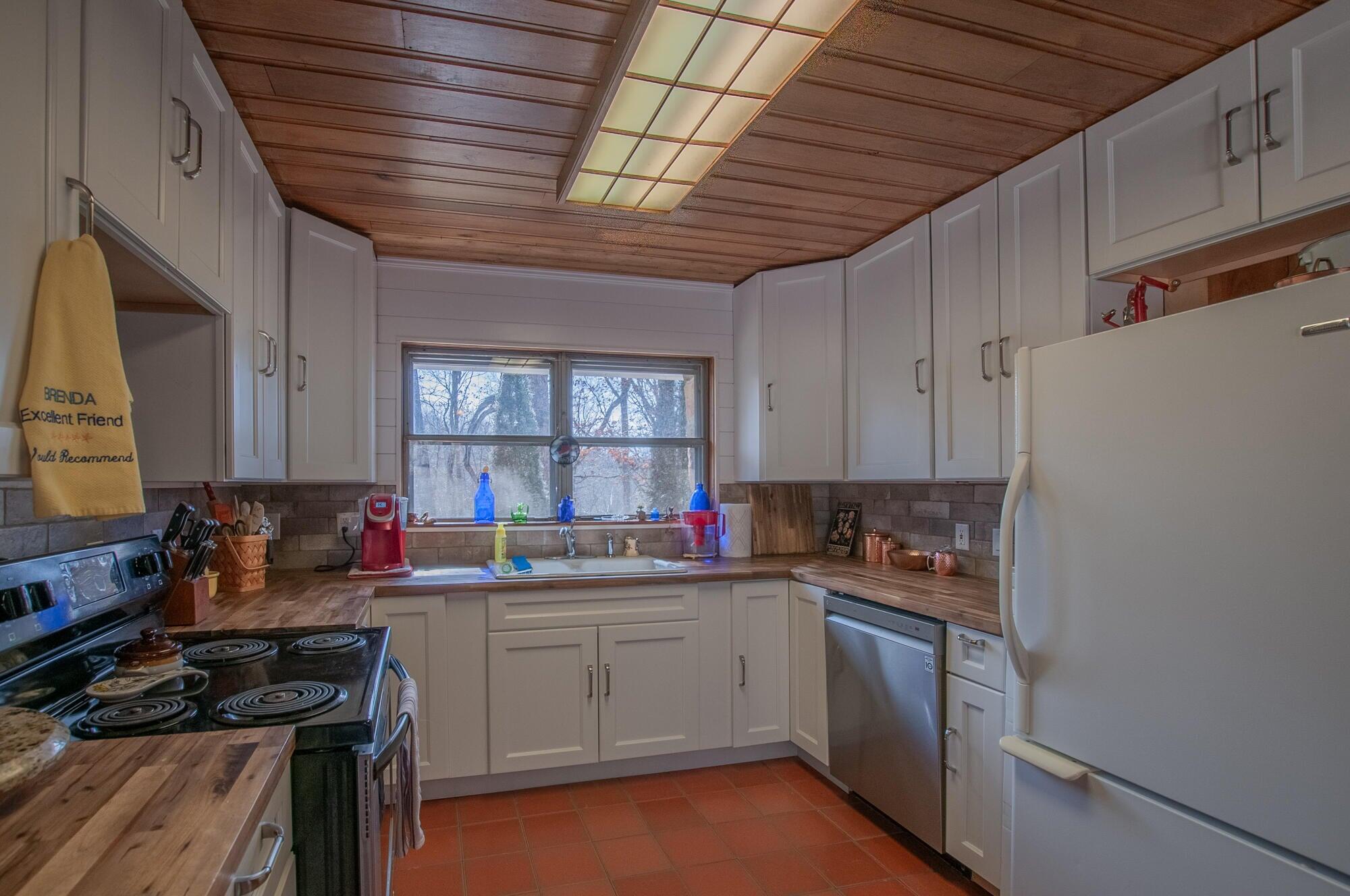 386 Fredericksburg Road Lexington, VA 24450 - Photo 19 of 72 a kitchen with a sink stove and cabinets