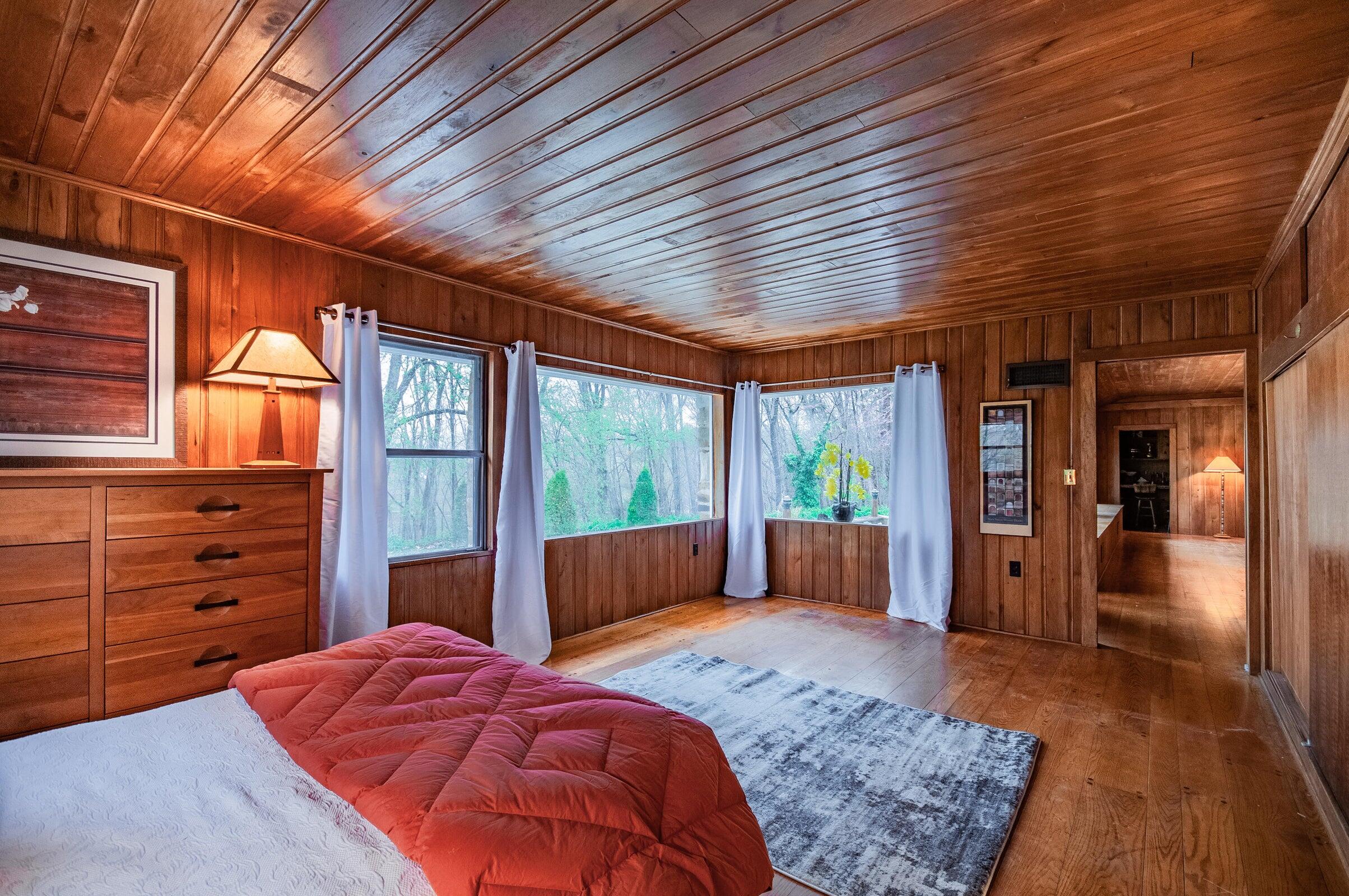 386 Fredericksburg Road Lexington, VA 24450 - Photo 26 of 72 a bedroom with a large bed and wooden floor