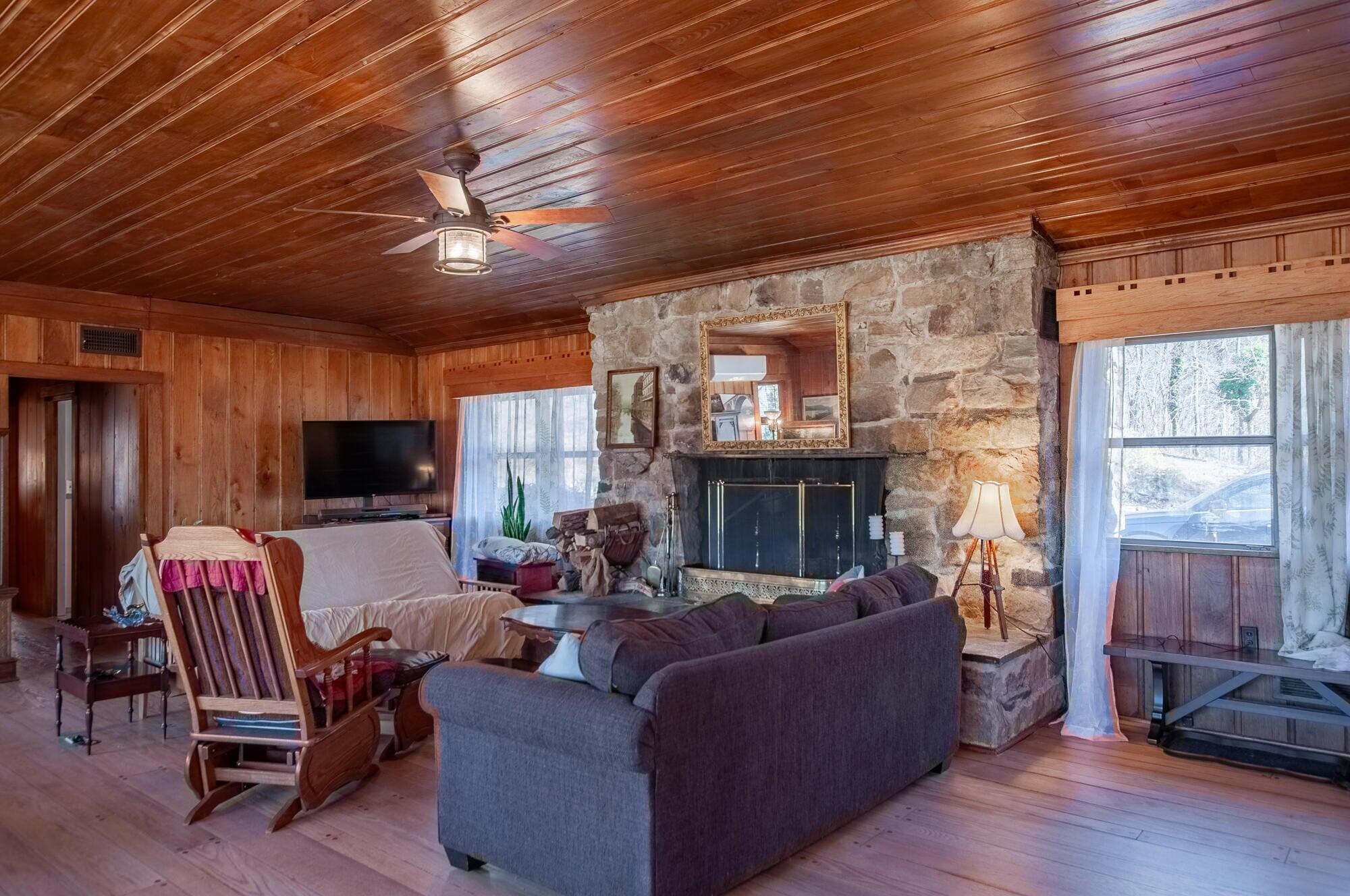 386 Fredericksburg Road Lexington, VA 24450 - Photo 72 of 72 a living room with furniture a flat screen tv and a fireplace