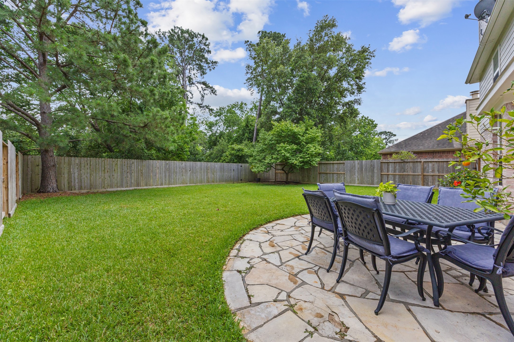 2219 Louetta Brook Lane Spring, TX 77388 - Photo 5 of 34 Spacious backyard with lush green lawn and mature trees offering privacy.