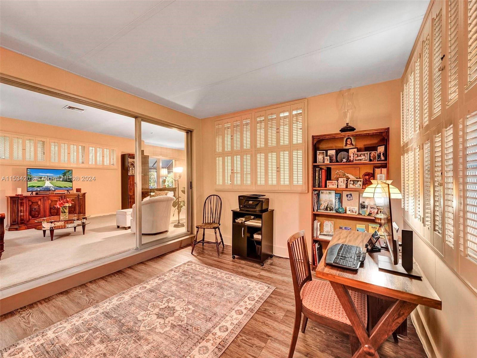 211 Southwest 24th Road Miami, FL 33129 - Photo 11 of 32 a view of a workspace with furniture and a window