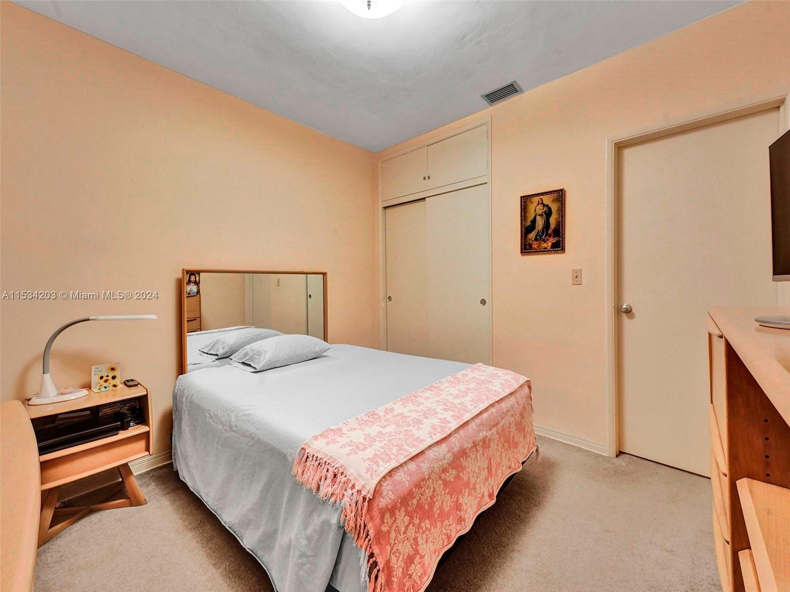 211 Southwest 24th Road Miami, FL 33129 - Photo 20 of 32 a bedroom with a bed and a lamp