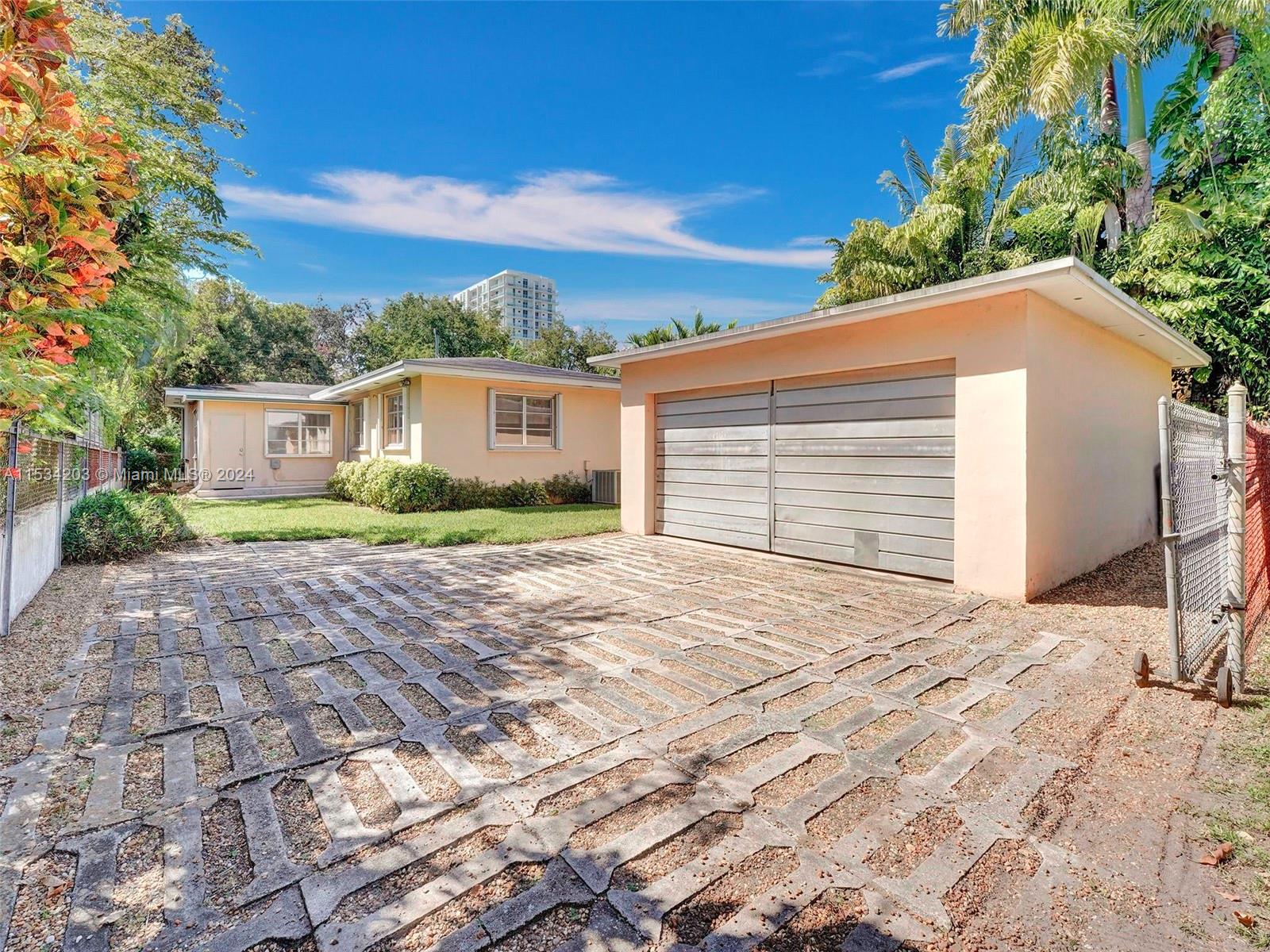 211 Southwest 24th Road Miami, FL 33129 - Photo 25 of 32 a front view of a house with a garden
