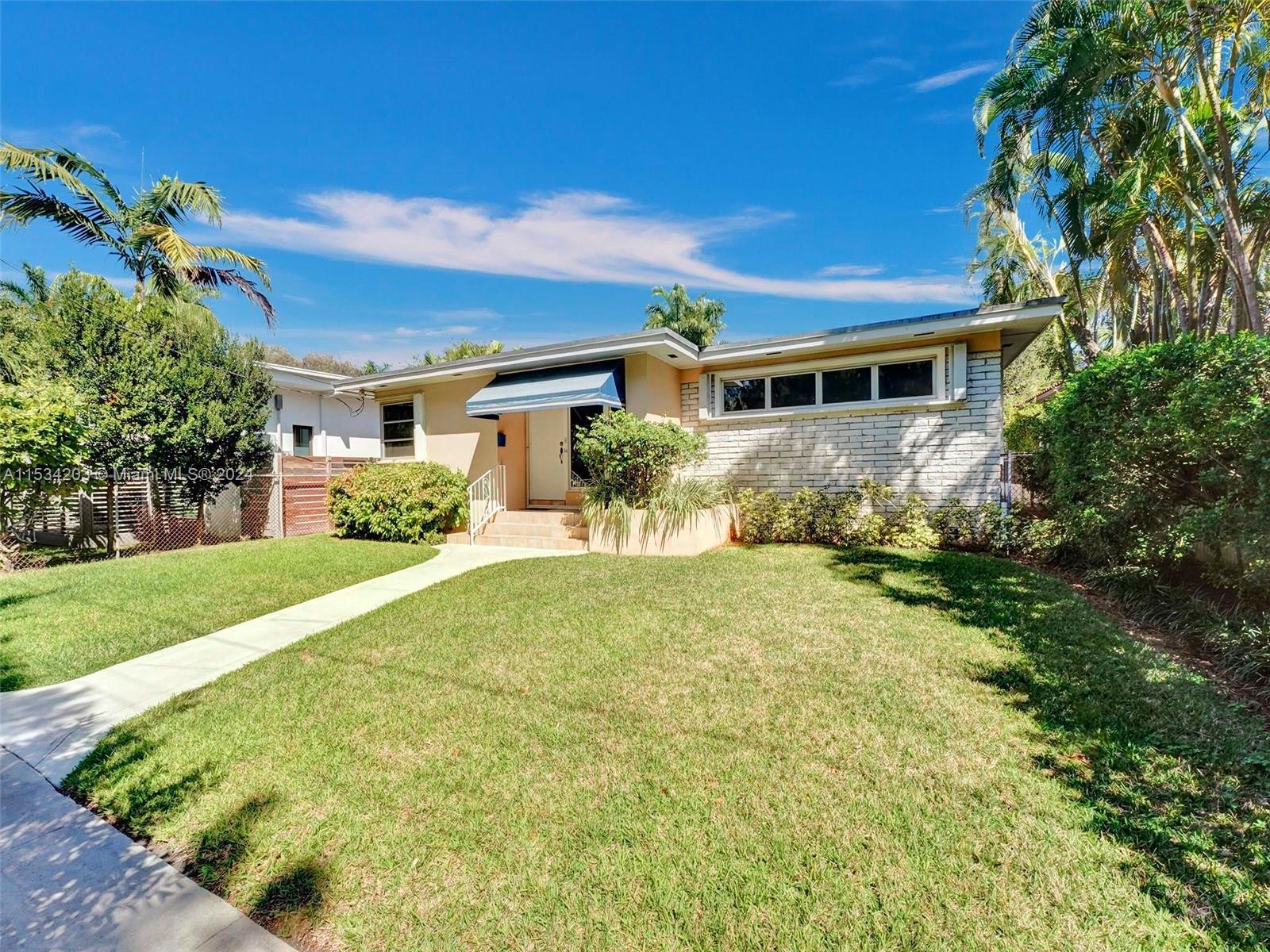 211 Southwest 24th Road Miami, FL 33129 - Photo 3 of 32 a front view of a house with a yard and potted plants