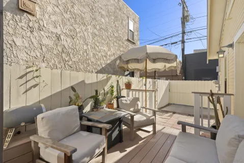 a balcony with table and chairs