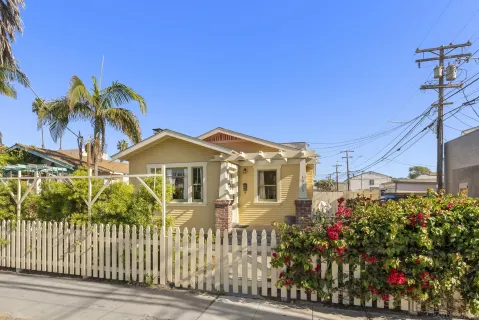 a front view of a house with a garden