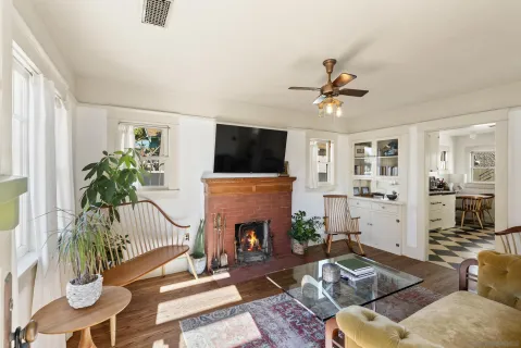 a living room with furniture a fireplace and a flat screen tv