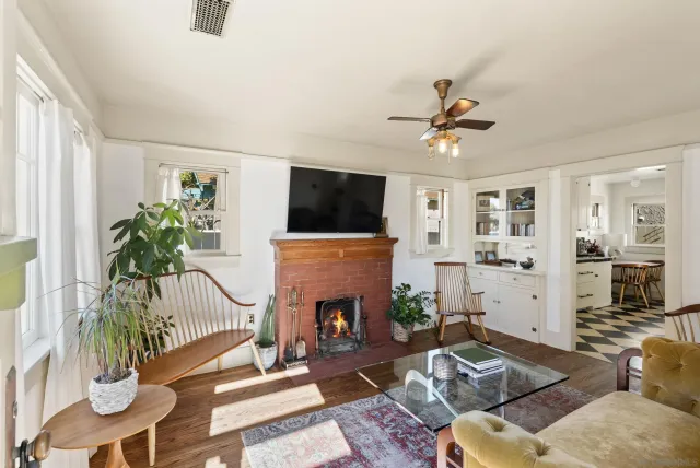 a living room with furniture a fireplace and a flat screen tv