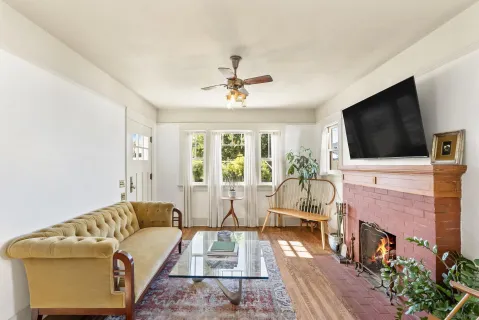 a living room with furniture a flat screen tv and a fireplace