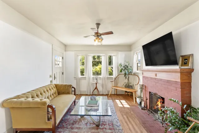 a living room with furniture a flat screen tv and a fireplace