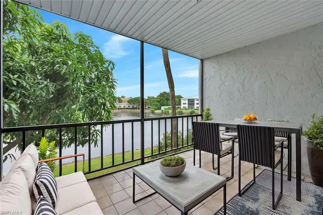 a view of a two chairs and table in the balcony