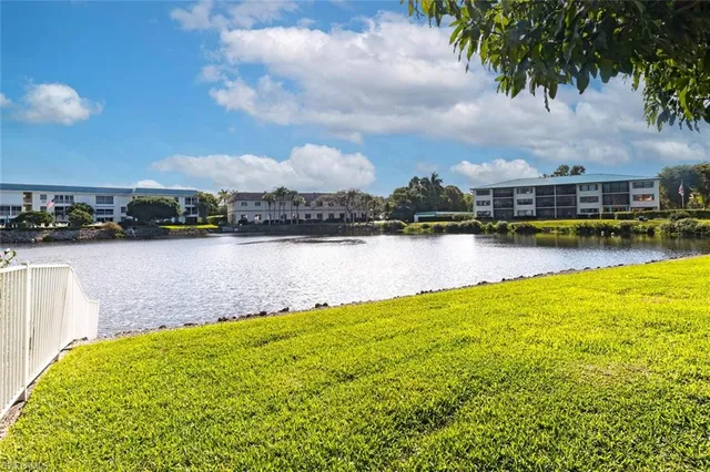 a view of a lake with houses in the back