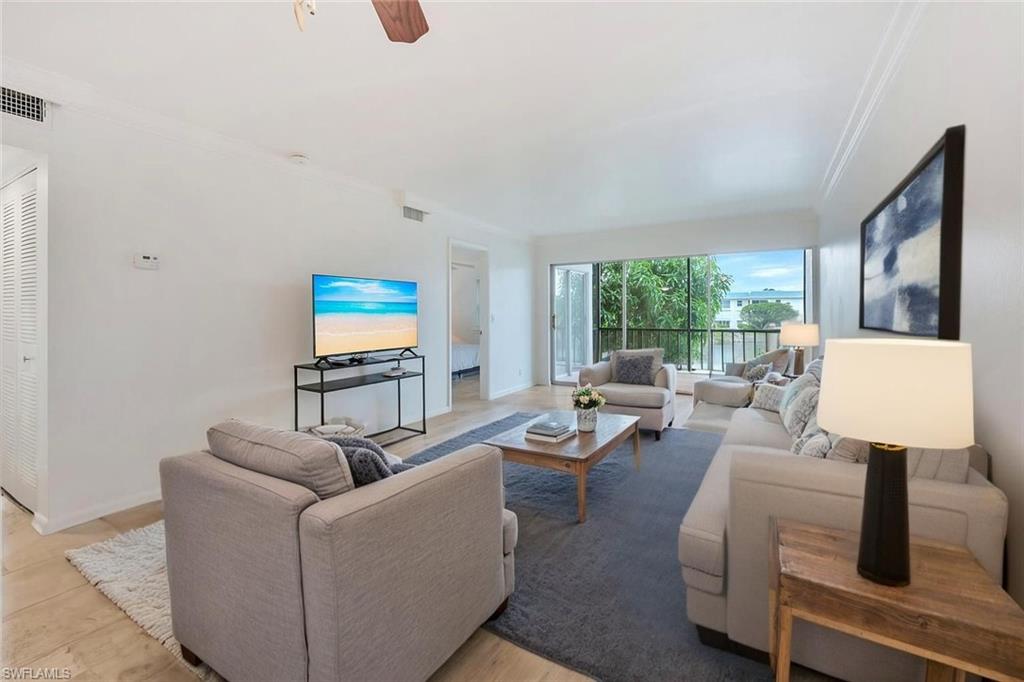 3030 Binnacle Drive, Unit 201 Naples, FL 34103 - Photo 2 of 16 a living room with furniture and a window