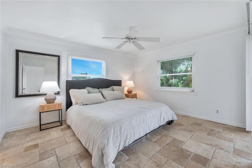 3030 Binnacle Drive, Unit 201 Naples, FL 34103 - Photo 4 of 16 a bedroom with a bed and a window