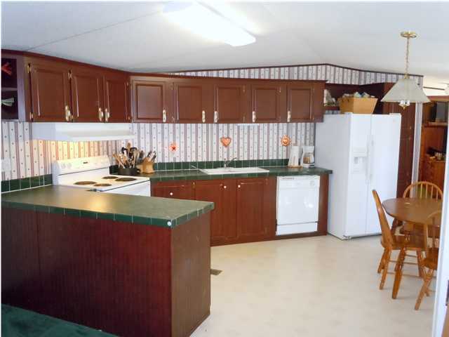 246 Long Road DeFuniak Springs, FL 32433 - Photo 2 of 19 a kitchen with a sink a stove a refrigerator and a microwave