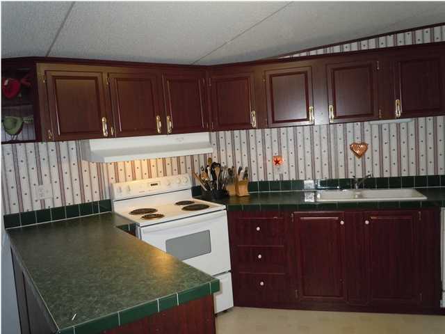 246 Long Road DeFuniak Springs, FL 32433 - Photo 3 of 19 a kitchen with a sink a stove and cabinets
