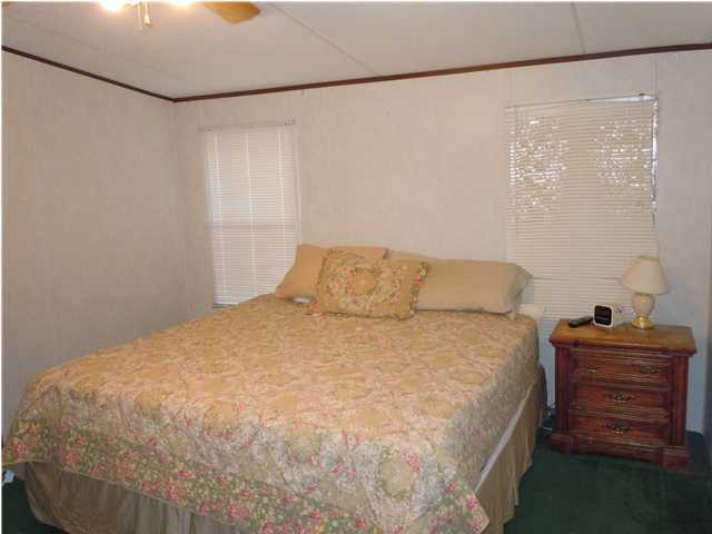 246 Long Road DeFuniak Springs, FL 32433 - Photo 7 of 19 a large bed sitting in a room next to a window